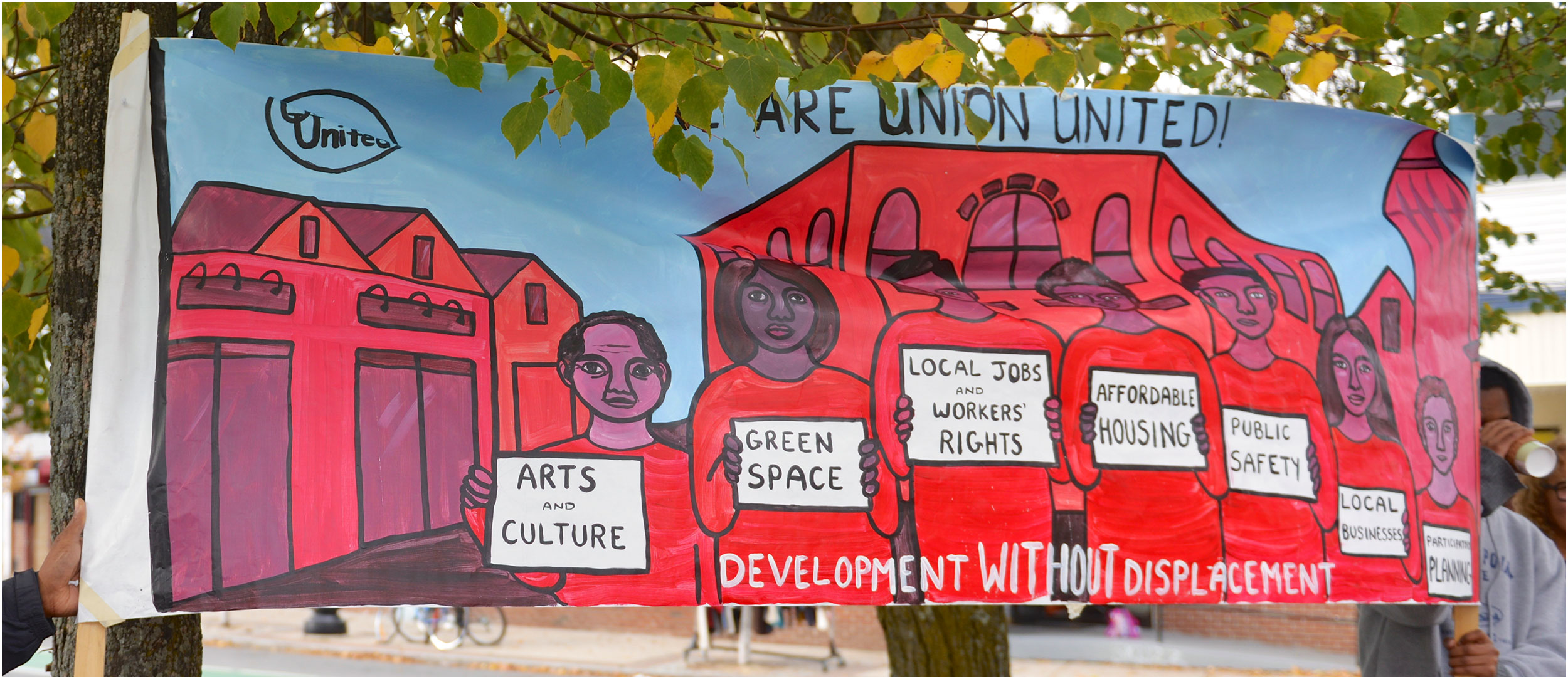 image of a man next to a colorful banner